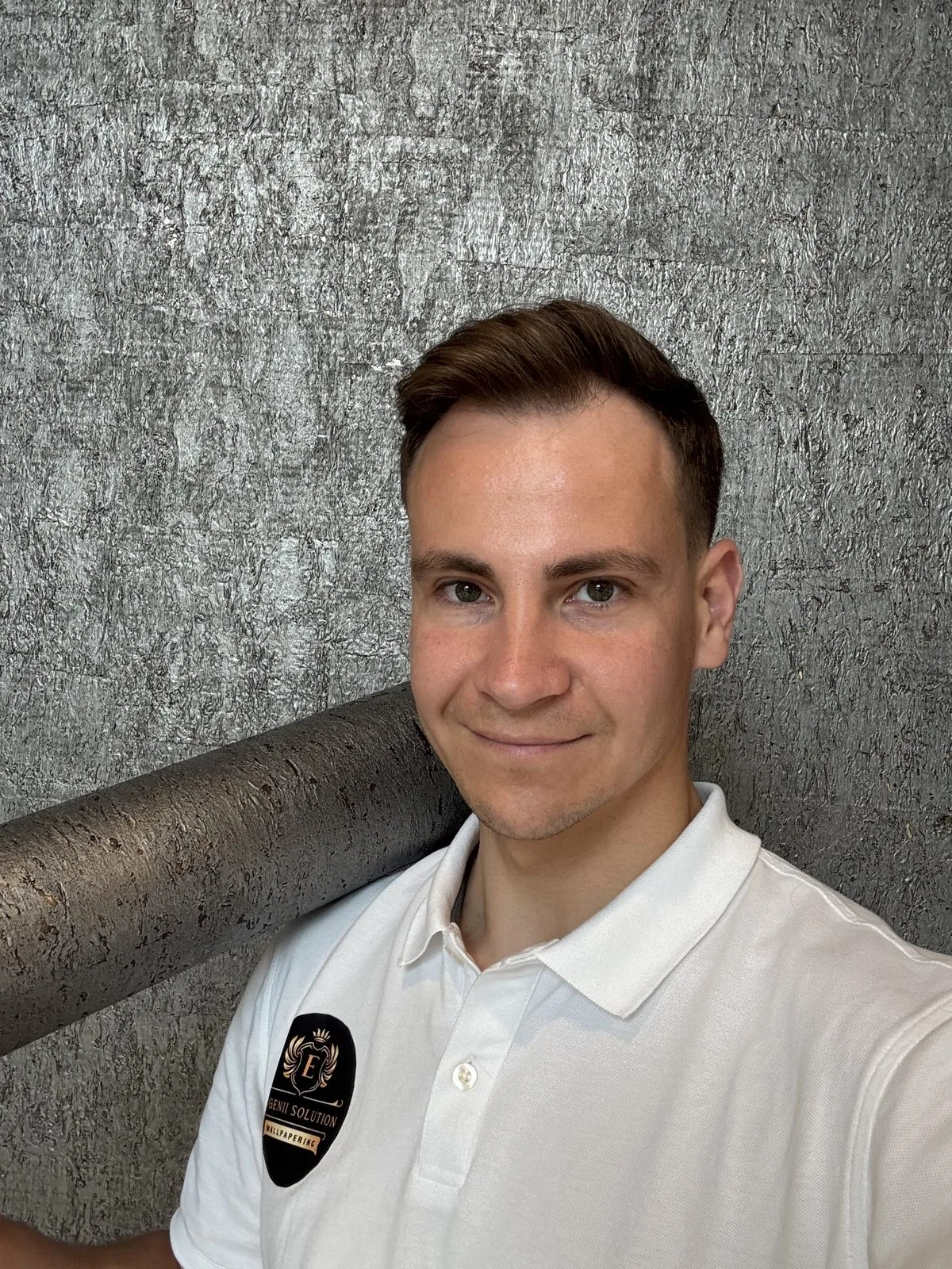 Evgenii Solution installer with a roll of wallpaper
